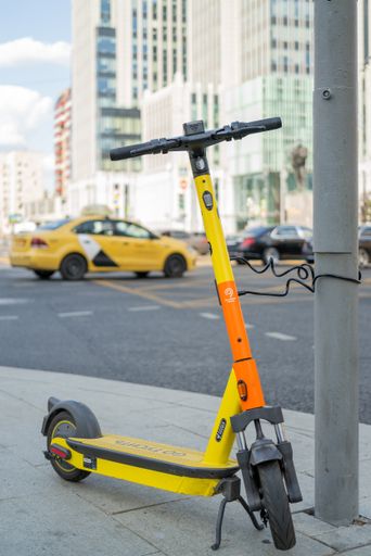 A vertical shot of a parked electric scooter at a rental service in Moscow, Russia