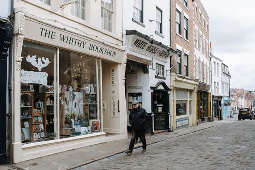 A shot of a street and a bookstore white shopwindow in historical seaside town Whitby, United Kingdom
