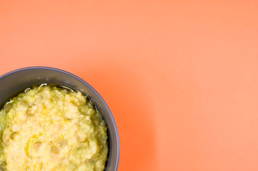 A top view of scrambled omelette on a bowl isolated on an orange background