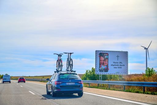 Freeway 20, Germany - September 15, 2019: Car with a bike carrier attached on the top and bicycles mounted on it.