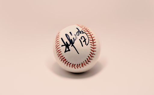 A closeup shot of a baseball signed by a former Cuban player