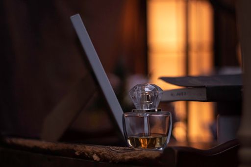 A selective focus of a luxurious glass perfume bottle on a wooden surface