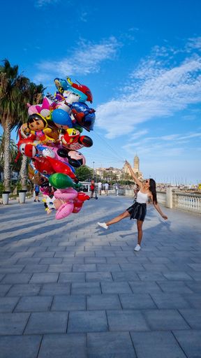 A vertical shot of a Hispanic woman posing for a picture during vacation