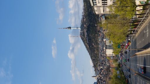 A scenic view of a busy road leading to a city under a clear sky