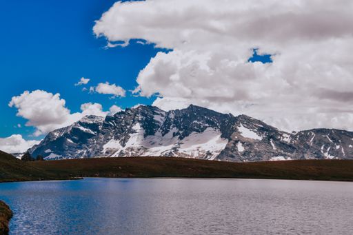 A scenic view from a natural reservation with tremendous mountains and a lake in Gran Paradiso, Italy
