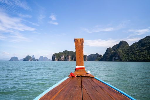 A Shot of limestone cliffs and sea taken from a longtail boat in the national park, Thailand