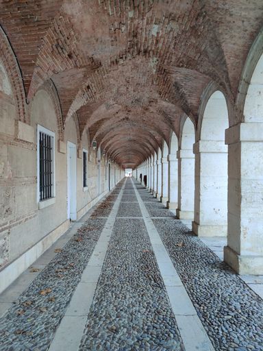 A vertical shot of the exterior corridor of the Royal Palace of Aranjuez in Spain
