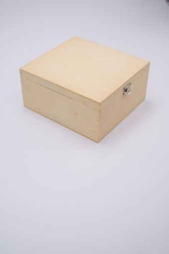 A vertical shot of a closed wooden box isolated on light gray background