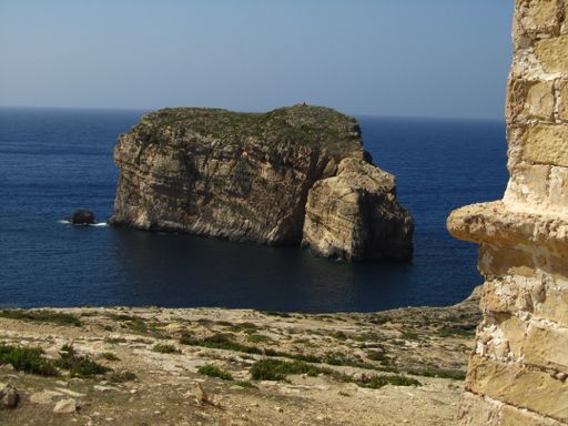 A small islet, known as Fungus Rock, or the General's Rock, off the coast of Dwejra, Gozo, Malta. Famous for a medicinal plant which grows on it.