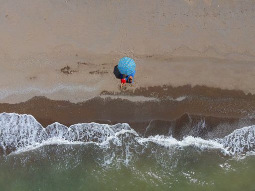 A top view of people tanning on the beach