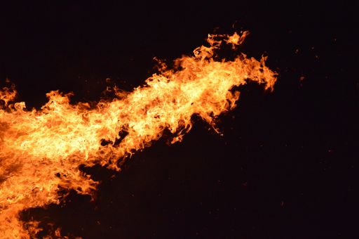 A closeup of fire flames in a darkness