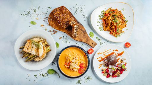 A top view of assorted dishes on a white table
