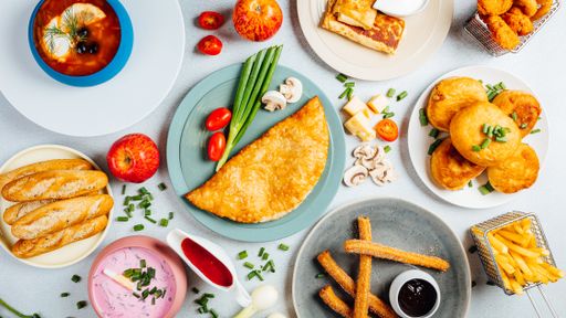 A top view of assorted dishes on a white table