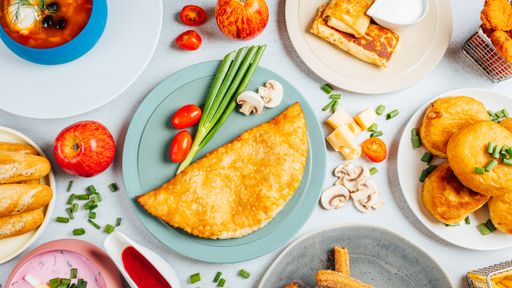 A top view of assorted dishes on a white table