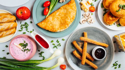 A top view of assorted dishes on a white table