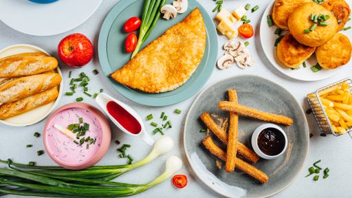 A top view of assorted dishes on a white table