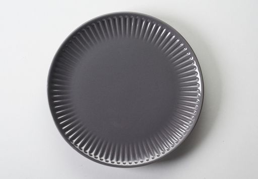 A top view of a gray ceramic flat plate on a white background