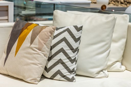 A closeup shot of different pillows on a couch