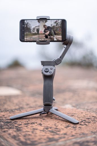 A vertical shot of a photographer taking a photo through the pho