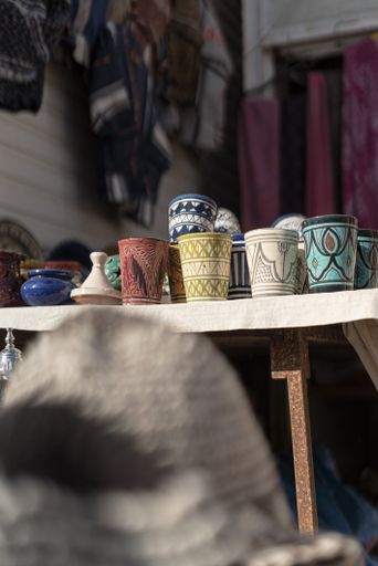 A store selling traditional maroccan cultural cloth, carpet and dishes made from the locals