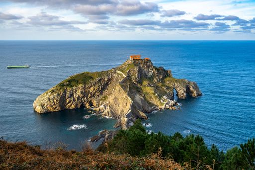 An aerial shot of San Juan de Gaztelugatxe islet surrounded by the Atlantic Ocean, Bermeo, Basque Country, Spain