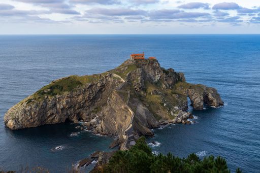 An aerial shot of San Juan de Gaztelugatxe islet surrounded by the Atlantic Ocean, Bermeo, Basque Country, Spain