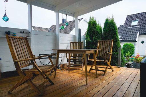 A wooden table with chairs on the terrace