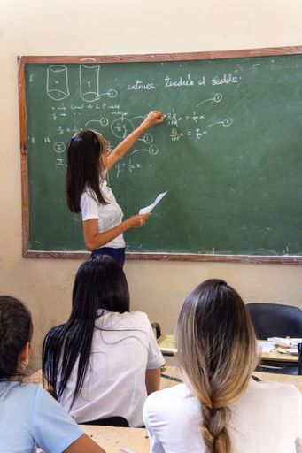 A classroom setting in Cuba with desks and chairs