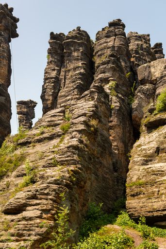 A vertical shot of a rocky mountains on a sunny day