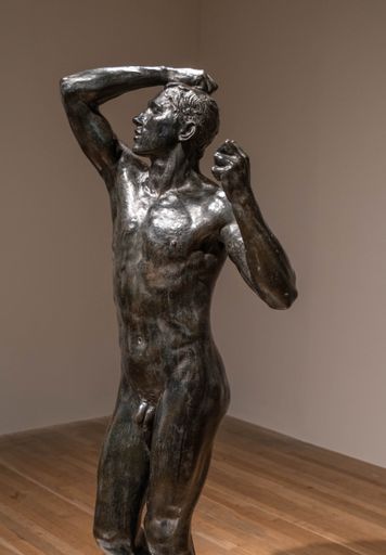 A vertical shot of the Age of Bronze at the exhibition The Making of Rodin in London, UK