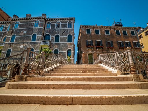 Bottom Top View across a Bridge with typical Venezia House architecture at the background