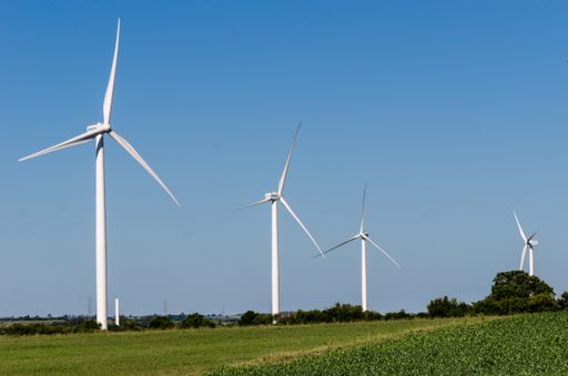 A beautiful landscape with four wind turbines in nature under the blue sky