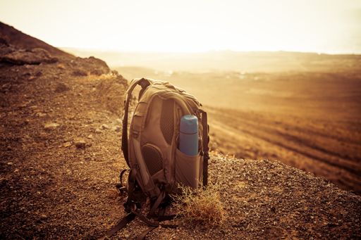 A close up shot of a hiker's backpack on sunset