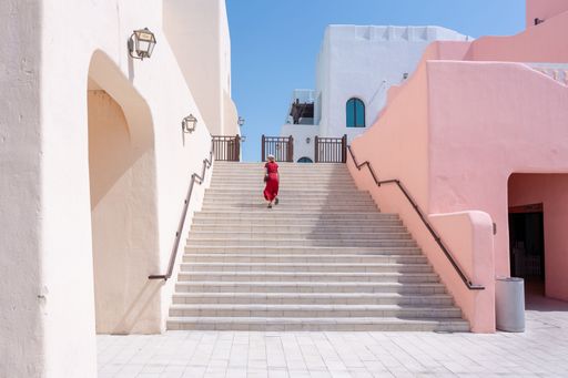 girl walking on the Colorful Streets in Mina District Corniche, Doha Marina, Doha, Qatar