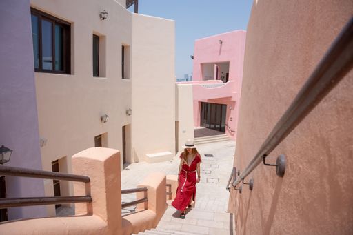 Girl walking on the Colorful Streets in Mina District Corniche, Doha Marina, Doha, Qatar