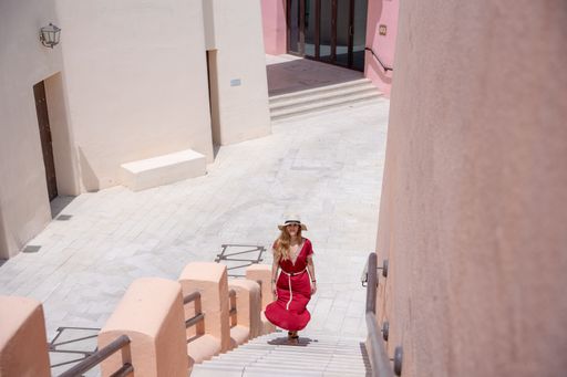 Girl walking on the Colorful Streets in Mina District Corniche, Doha Marina, Doha, Qatar