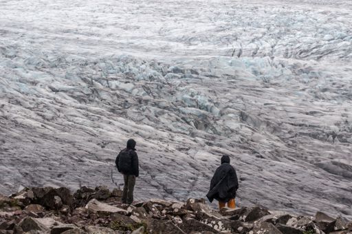 Two hikers enjoying the view of the Vatnajokull National Park from a peak