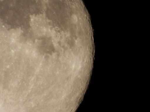 Detailed view of the moon's surface with craters against a black sky