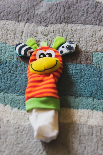 A vertical closeup shot of a funny colorful children's sock toy