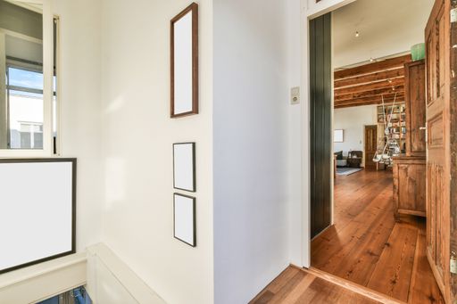 Some empty frames with copyspace on the wall in an apartment with vintage furniture