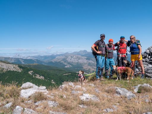 A closeup shot of a group of Caucasian people hiking in the mountains