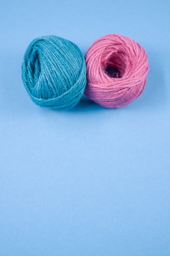 A top view of a colorful thread rope yarn on a blue background