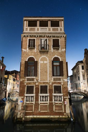 A vertical shot of the facade of an old apartment building
