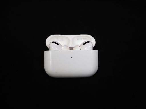Air Pods Pro. with Wireless Charging Case. New Airpods pro on black background. Airpods Pro. Copy space