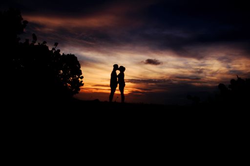 A silhouette shot of a couple kissing during a beautiful sunset in Mucura Island, Colombia