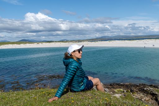 A female traveler admiring the scenery on Dog's Bay beach in Galway Ireland