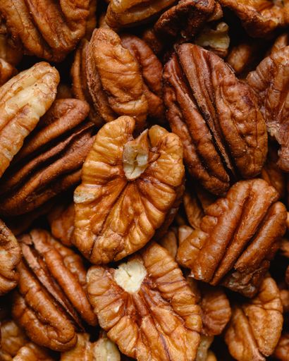 A top view closeup of fresh walnuts piled up