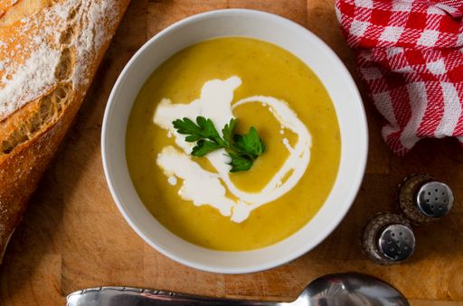 A high angle shot of a bowl of delicious homemade soup with vegetable