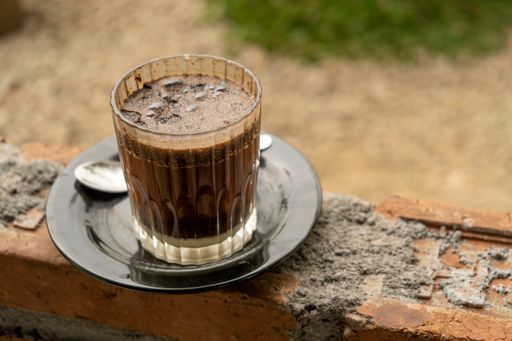 A closeup shot of a glass of iced coffee on a table