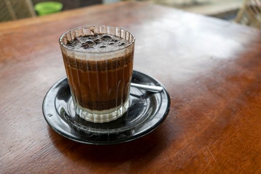 A closeup shot of a glass of iced coffee on a table